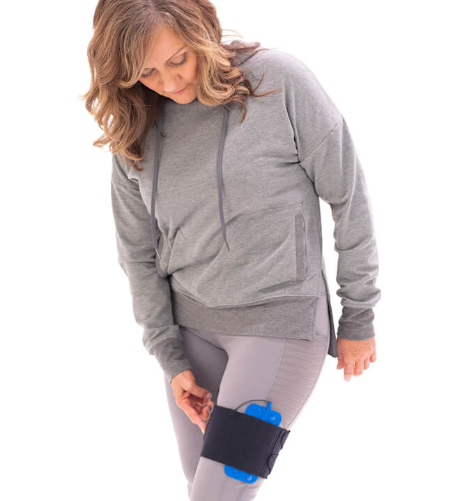 Female wearing a Peripheral Nerve Stimulation wearable on her calf, made by Curonix.
