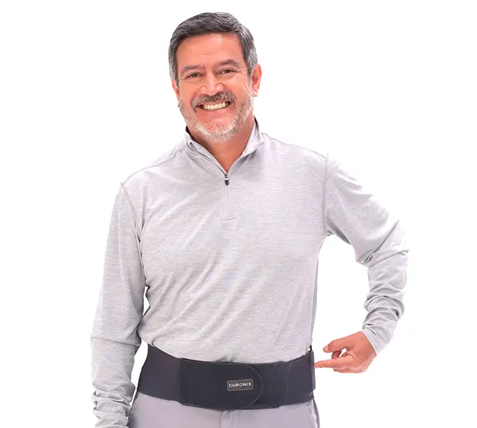 A male man wearing the Spinal Cord Stimulator wearable around his waist, made by Curonix.